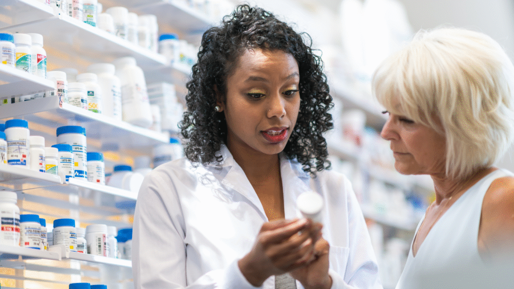 Pharmacist at a counter assisting a patient
