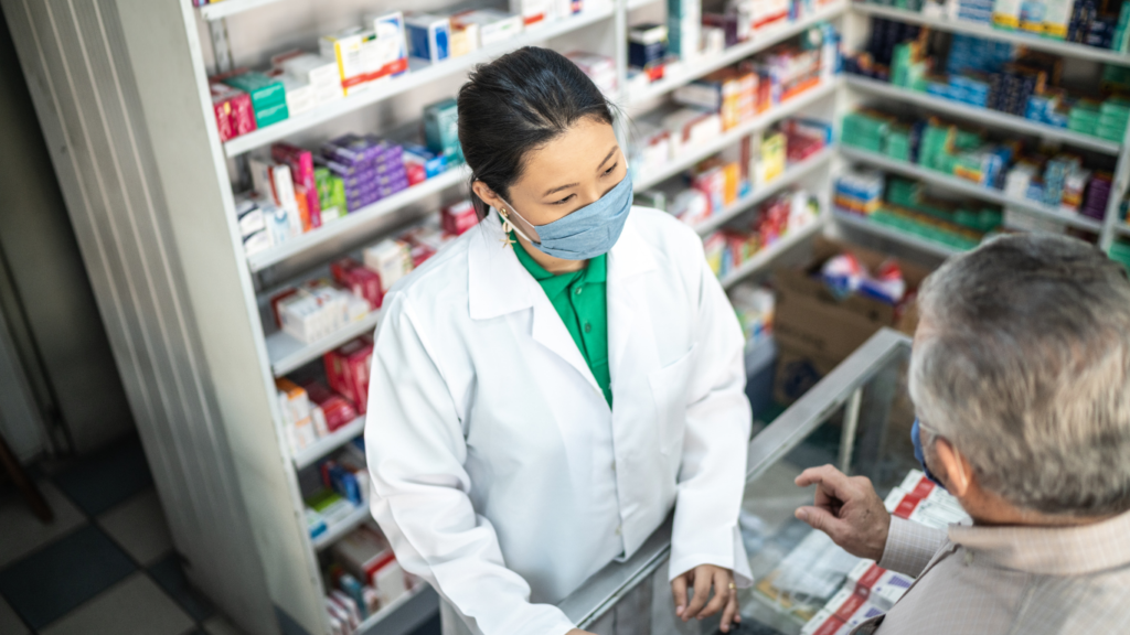 Nighttime pharmacist helping a customer