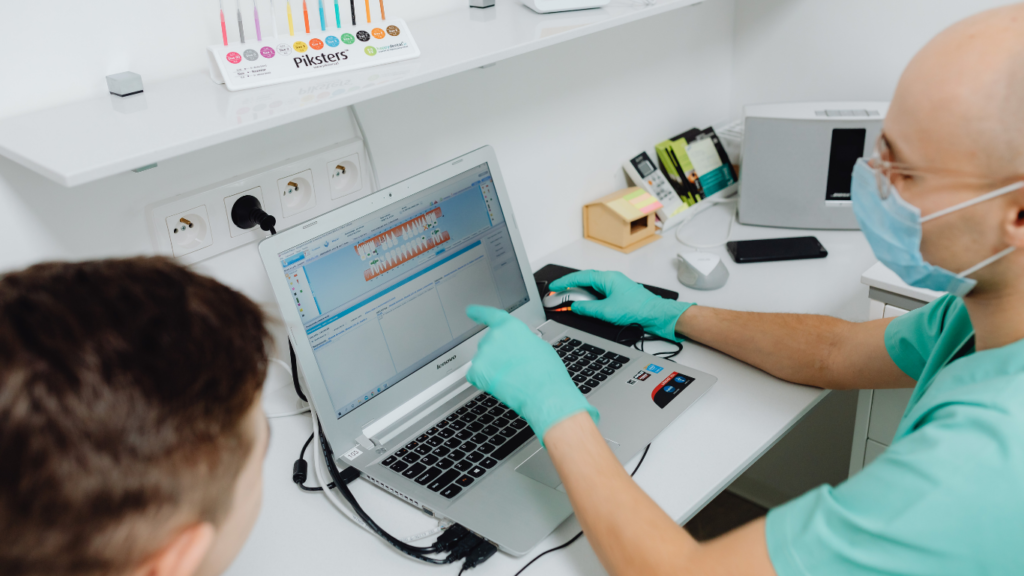 pharmacist assisting a patient on a computer