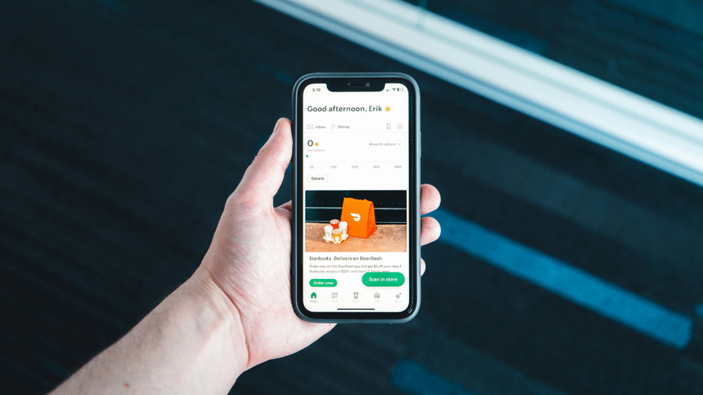 Delivery driver checking a mobile app before a delivery