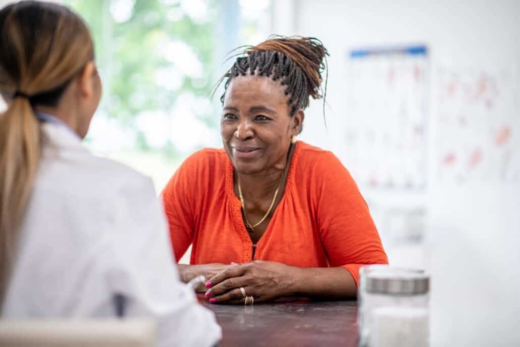 A doctor consulting a patient about medication safety in a clinical setting