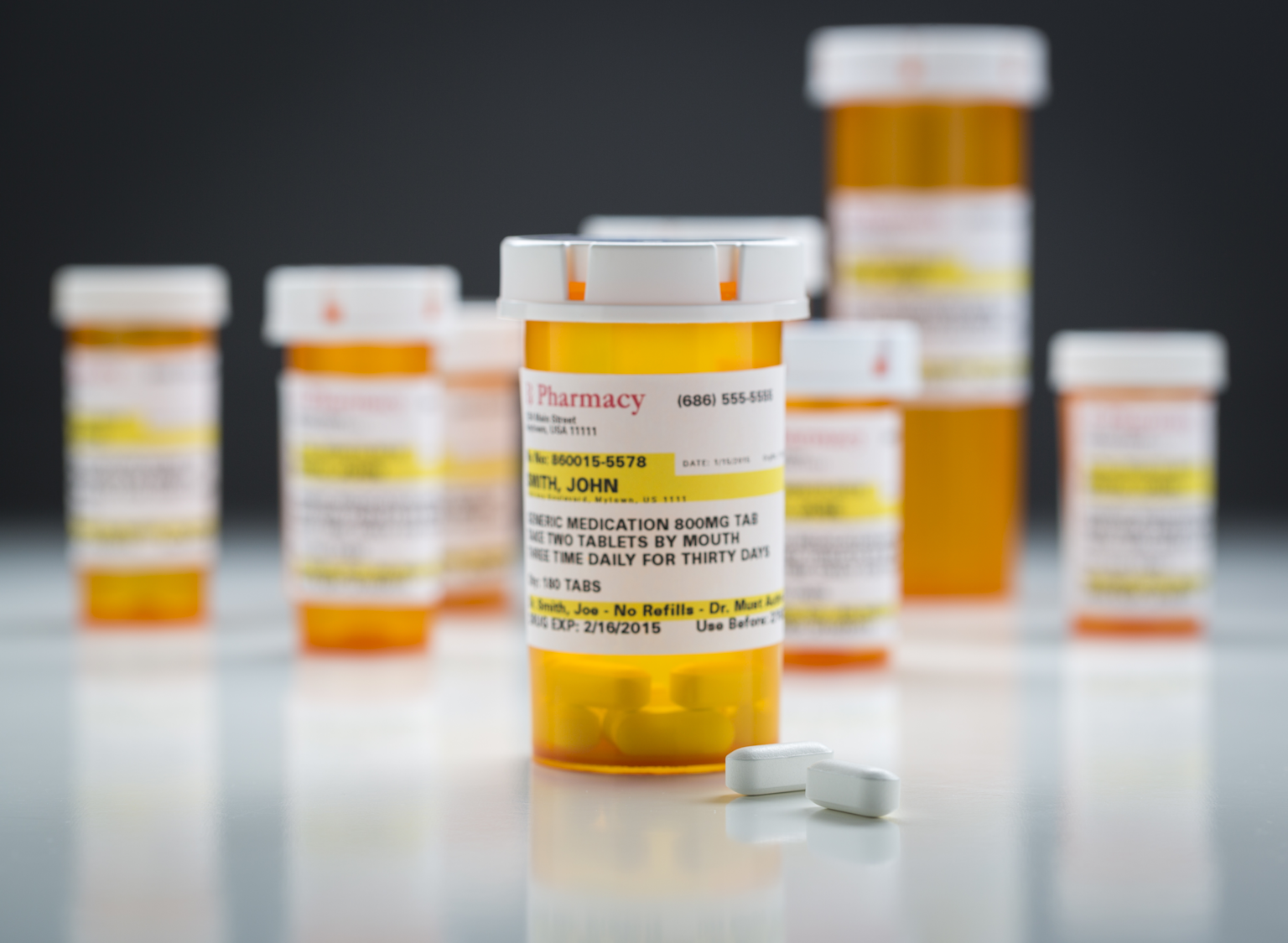 Prescription medication bottles and tablets representing pharmacy prescription services