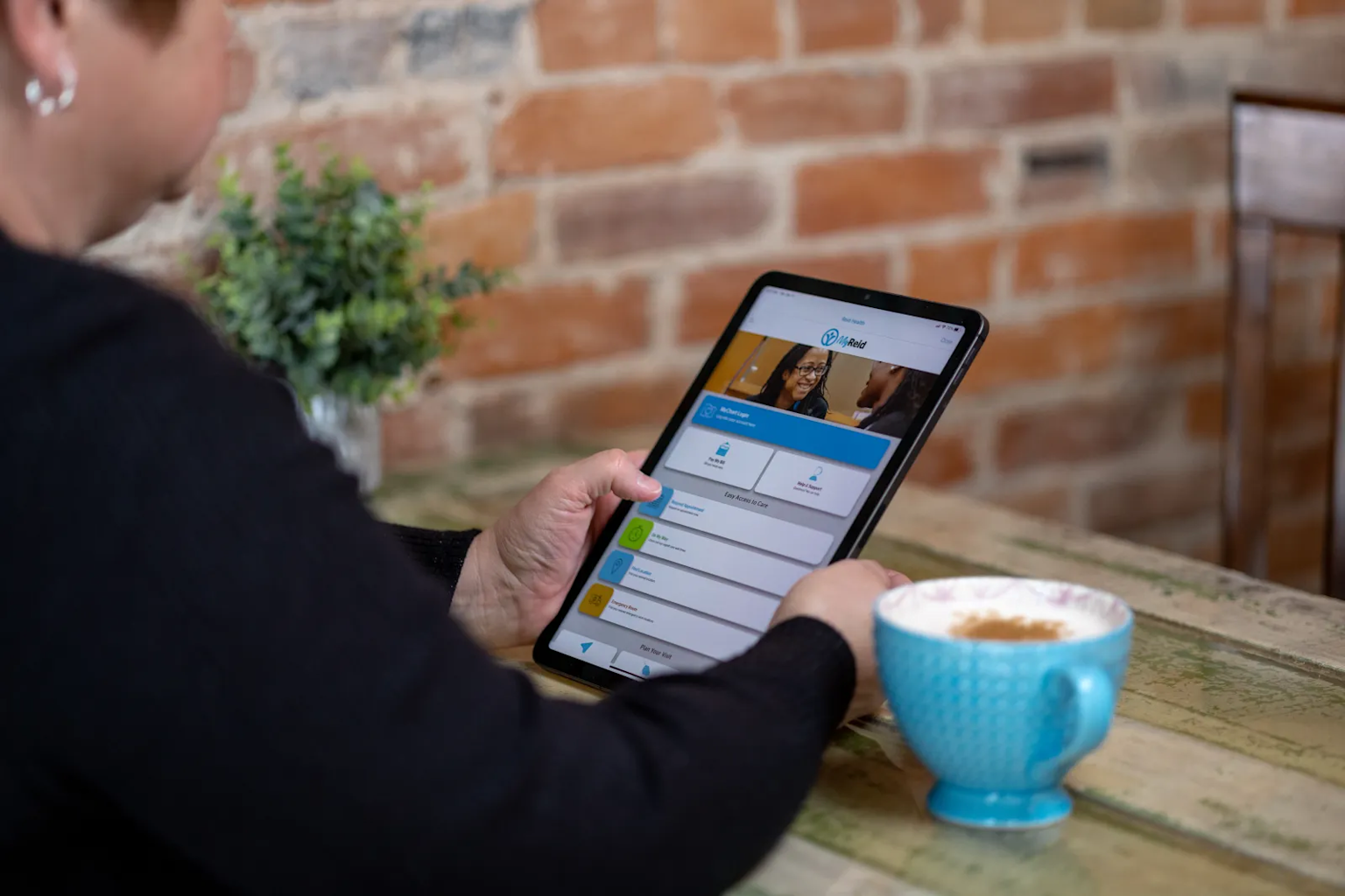 A person using a digital app on a tablet to manage and refill prescriptions conveniently from home