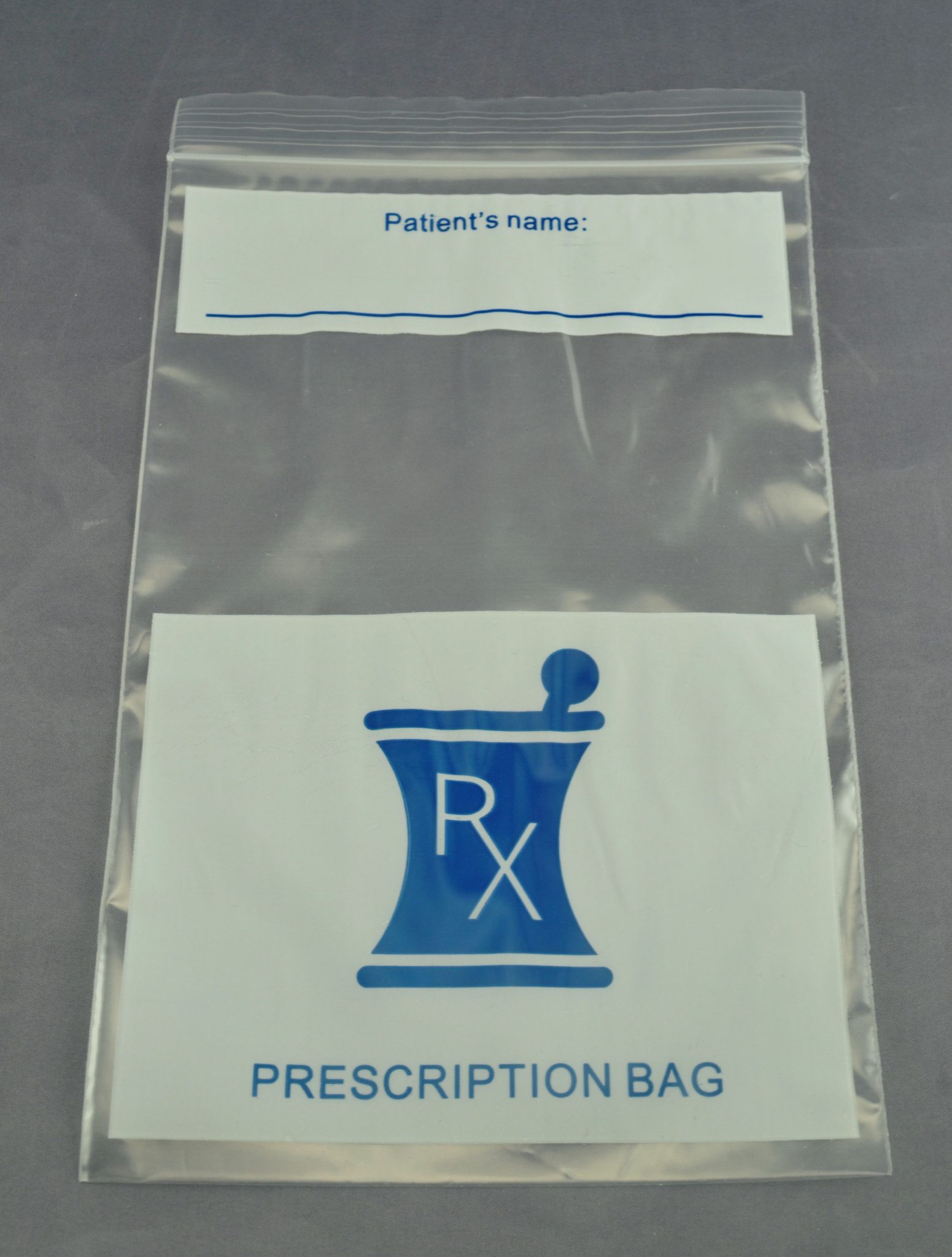 Clear prescription bag with space for patient name and pharmacy Rx symbol indicating medication storage and transport