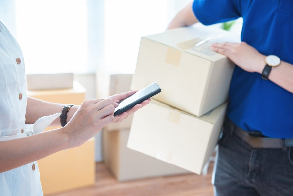 Delivery driver using a smartphone to verify and handle packages during a delivery interaction