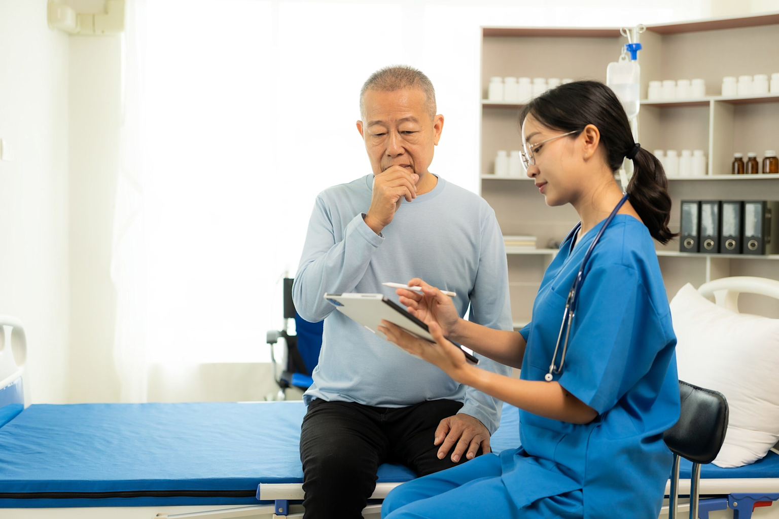 A healthcare professional consults with a patient in a clinical setting, illustrating patient care and professional healthcare communication