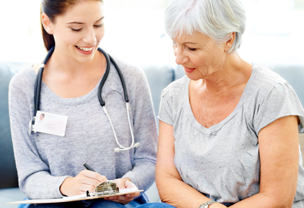 Elderly patient consulting with a healthcare professional during a medical appointment for prescription management